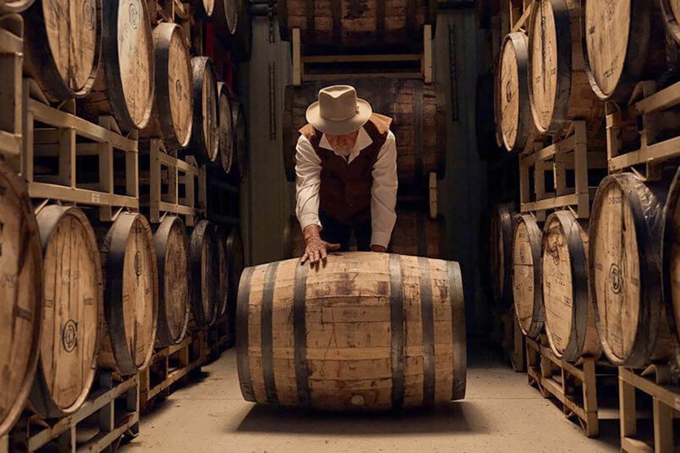 Tim Trites rolls a barrel of spirits at his distillery outside Pinedale.