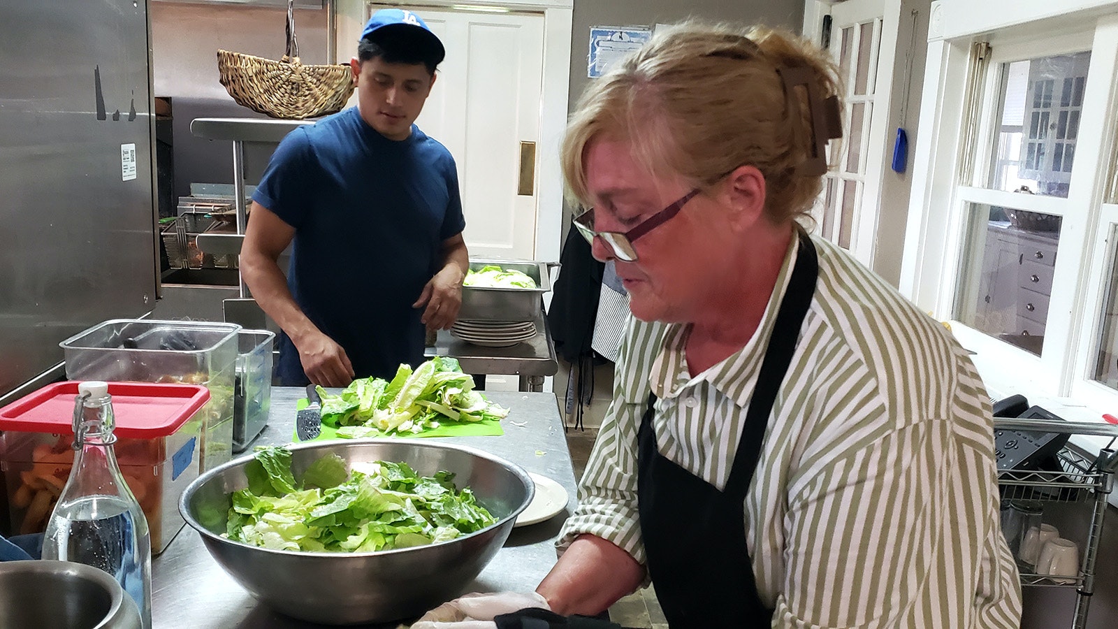 Preparing salads in the kitchen of the cookhouse.