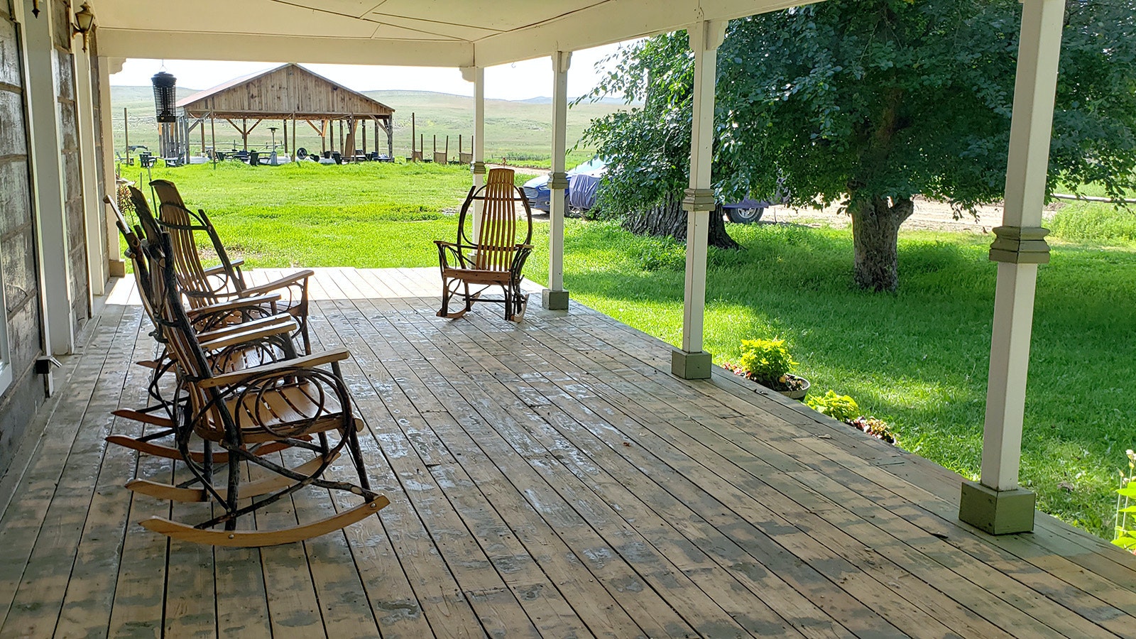 The porch has a nice view of the ranch with plenty of rocking chairs to sit a spell.